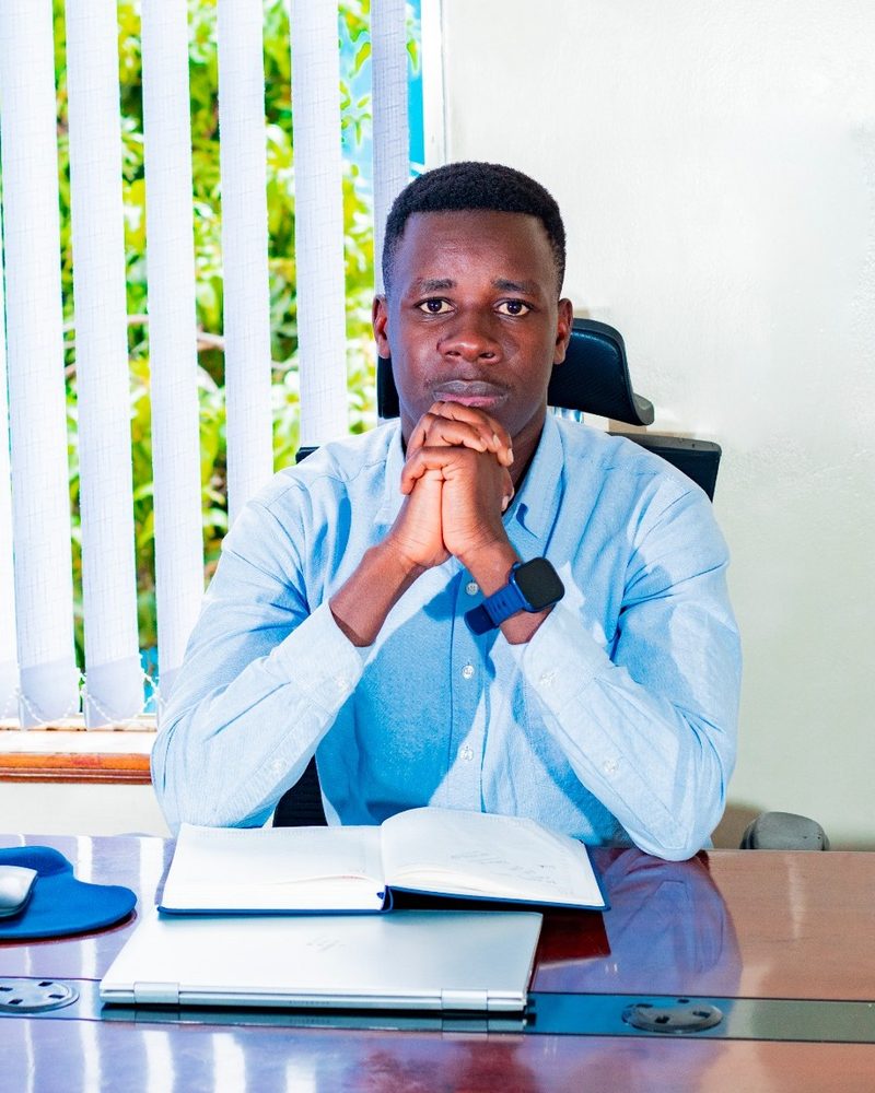 Portrait of Preston Wagabi, Operations Officer at WikiTeq Solutions, seated at his desk